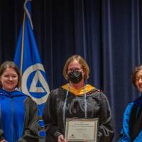 Provost Mili takes picture at awards ceremony